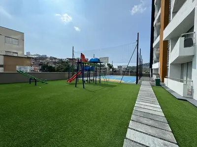 a playground on the side of a building with green grass at BALMORAL in Manizales