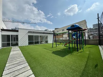 a playground on the roof of a building with green grass at BALMORAL in Manizales