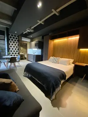 a bedroom with a large bed and a table at Recinto68 in Medellín