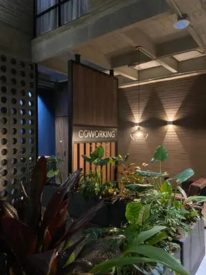 a lobby with plants and a sign that reads computing at Recinto68 in Medellín