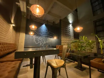 a dining room with a table and chairs and lights at Recinto68 in Medellín