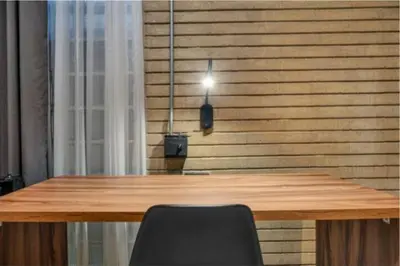 a wooden table with a light on a wooden wall at Recinto68 in Medellín