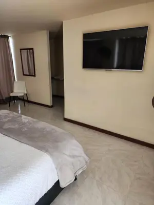 a bedroom with a bed and a flat screen tv at Eco hotel Torino in Tarso