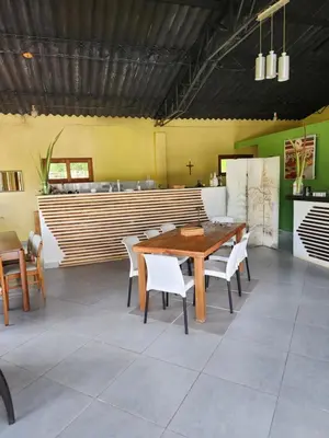a dining room with a wooden table and chairs at Eco hotel Torino in Tarso