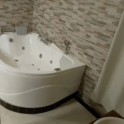 a white bath tub sitting in a bathroom at Hotel santa fe plaza sucursal HBP in Santa Fe de Antioquia