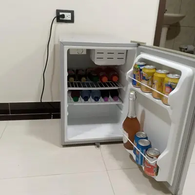 an open refrigerator with food and drinks in it at Hotel santa fe plaza sucursal HBP in Santa Fe de Antioquia