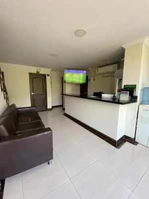 a lobby with a waiting room with a couch and a counter at Hotel santa fe plaza sucursal HBP in Santa Fe de Antioquia