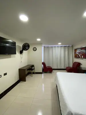 a hotel room with a bed and a desk at Hotel santa fe plaza sucursal HBP in Santa Fe de Antioquia