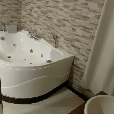 a white bath tub in a bathroom with a toilet at Hotel santa fe plaza sucursal HBP in Santa Fe de Antioquia