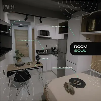 a room with a kitchen with a table and a room soul at INVERSO Coliving in Medellín