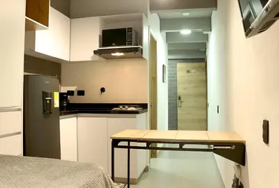 a small kitchen with a table in a room at INVERSO Coliving in Medellín