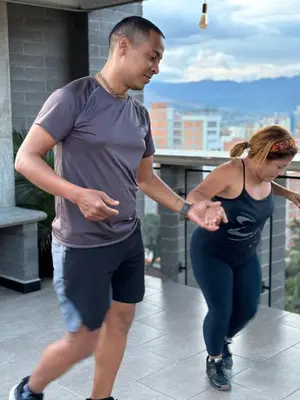 a man and a woman walking down a sidewalk at INVERSO Coliving in Medellín