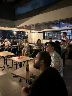 a group of people sitting at tables in a restaurant at INVERSO Coliving in Medellín