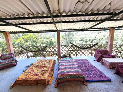 a room with two beds and chairs on a roof at Hospedaje Pa'Gaïa in San Rafael