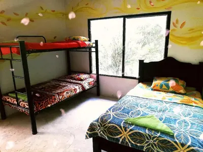 a bedroom with two bunk beds and a window at Hospedaje Pa'Gaïa in San Rafael