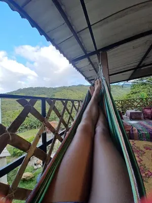 a person laying in a hammock with their feet up at Hospedaje Pa'Gaïa in San Rafael