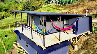 an overhead view of a house with hammocks on it at Hillside Cabins - Guatapé in Medellín