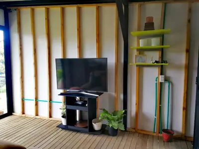a tv sitting on a stand in a room at Hillside Cabins - Guatapé in Medellín