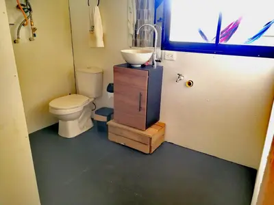 a bathroom with a toilet and a sink at Hillside Cabins - Guatapé in Medellín