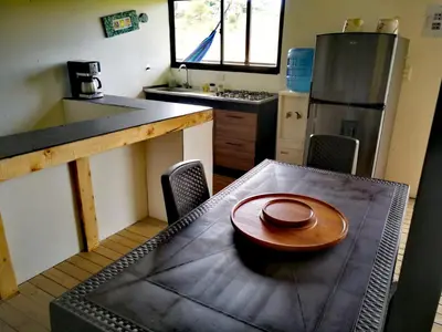 a kitchen with a table with a plate on it at Hillside Cabins - Guatapé in Medellín