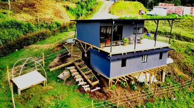 a house sitting on top of a hill at Hillside Cabins - Guatapé in Medellín