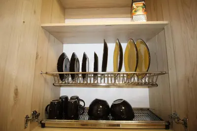 a row of plates on a shelf in a kitchen at Nueva Tiny House en el Poblado FRN110 By Roots Rentals in Medellín