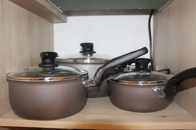 three pots and pans sitting on a shelf in a kitchen at Nueva Tiny House en el Poblado FRN110 By Roots Rentals in Medellín