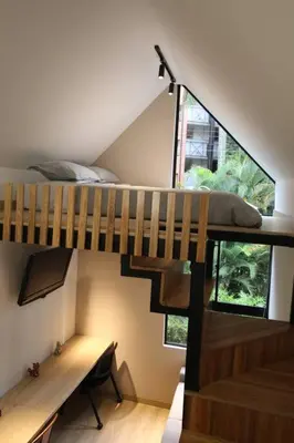 a bedroom with a bunk bed and a staircase at Nueva Tiny House en el Poblado FRN110 By Roots Rentals in Medellín