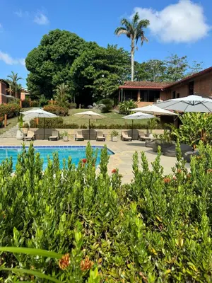a resort with a swimming pool with umbrellas at Casa Fuego in La Pintada
