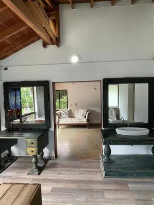 a living room with two mirrors and a couch at Casa Fuego in La Pintada