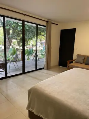 a bedroom with a bed and a sliding glass door at Casa Fuego in La Pintada