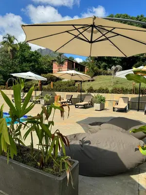 a patio with tables and umbrellas and chairs and sidx sidx sidx at Casa Fuego in La Pintada