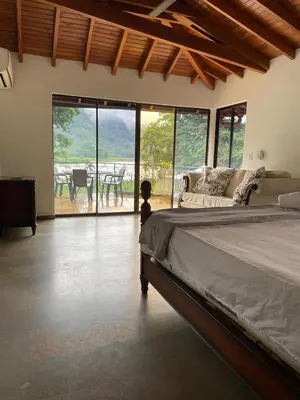 a bedroom with a bed and a view of a patio at Casa Fuego in La Pintada