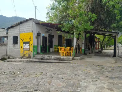 a building with tables and chairs outside of it at Casa Rio y Montaña Low cost in Honda