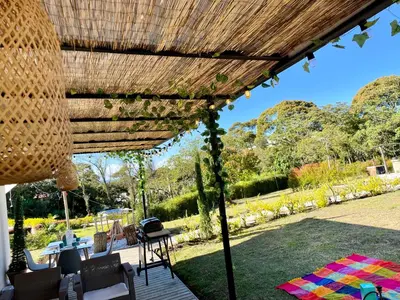 a patio with a wooden pergola and a table at Casa campestre descanso relajación jacuzzi BBQ amplias zonas verdes in Carmen de Viboral