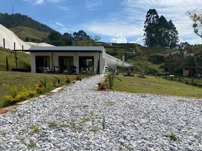 a house with a gravel path in front of a building at Casa campestre descanso relajación jacuzzi BBQ amplias zonas verdes in Carmen de Viboral