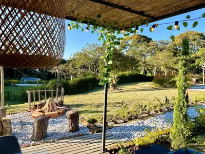 a view of a garden from under a pergola at Casa campestre descanso relajación jacuzzi BBQ amplias zonas verdes in Carmen de Viboral