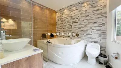 a bathroom with a tub and a toilet and a sink at Nuevo Apartamento a 2 minutos del JMC jacuzzi in Rionegro