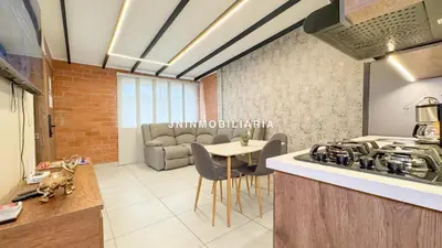 a kitchen and living room with a stove and a table at Nuevo Apartamento a 2 minutos del JMC jacuzzi in Rionegro