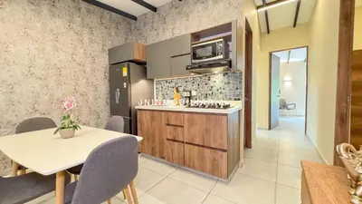 a kitchen with a table and a counter with a microwave at Nuevo Apartamento a 2 minutos del JMC jacuzzi in Rionegro
