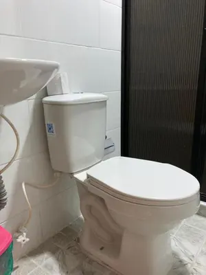 a bathroom with a white toilet and a sink at Hotel Mallorca Estadio, Medellin in Medellín