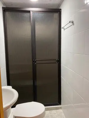 a bathroom with a shower with a toilet and a sink at Hotel Mallorca Estadio, Medellin in Medellín