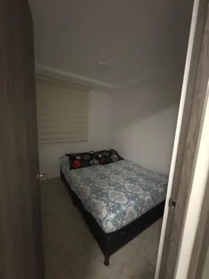 a small bedroom with a bed in a room at Apartamento Nogales in Bello