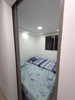 a small bedroom with a bed in a room at Apartamento Nogales in Bello