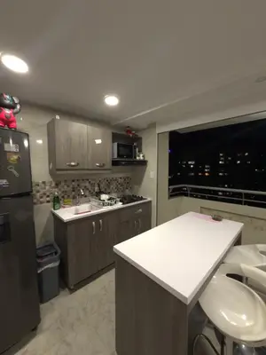 a kitchen with a refrigerator and a counter top at Apartamento Nogales in Bello