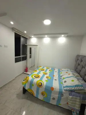 a bedroom with a bed with a colorful comforter at Apartamento Nogales in Bello
