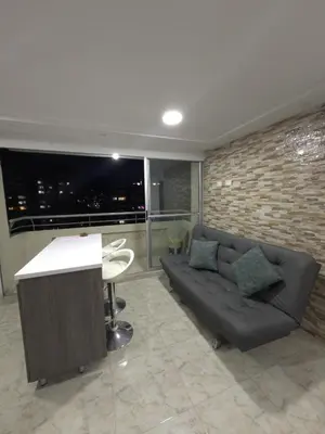 a living room with a couch and a table at Apartamento Nogales in Bello