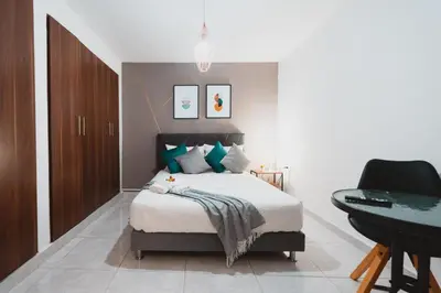 a bedroom with a bed and a desk at AC - House Laureles - Self Cheking in Medellín