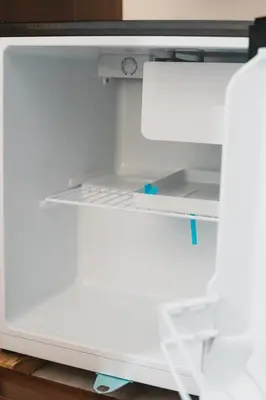an empty refrigerator with its door open at AC - House Laureles - Self Cheking in Medellín