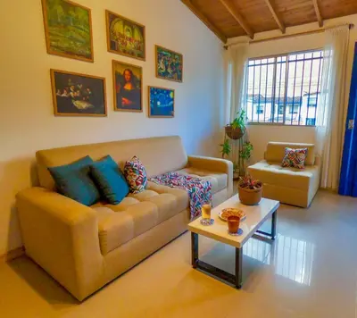 a living room with a couch and a table at Azulejo - Guest House in Medellín